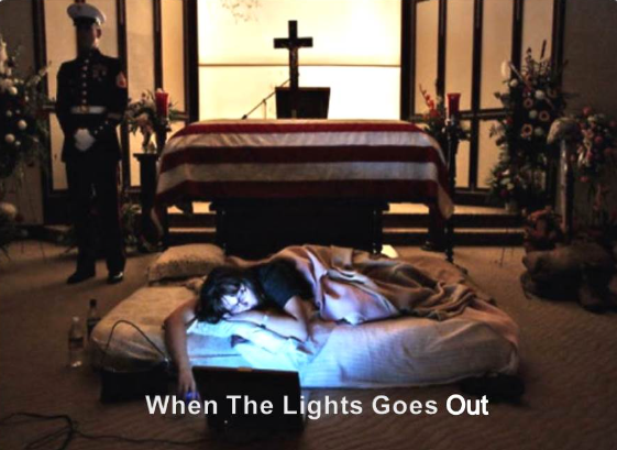 A grieving family member resting beside a flag-draped casket — When The Lights Goes Out